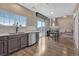 Open kitchen area with modern appliances, wood flooring, and abundant natural light from adjacent outdoor area at 18668 E Vassar Dr, Aurora, CO 80013