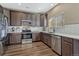 Well-equipped kitchen featuring stainless steel appliances, wood-style floor, and ample counter space at 18668 E Vassar Dr, Aurora, CO 80013