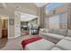 Bright living room featuring a fireplace, large windows, and an open floorplan flowing into the kitchen at 18668 E Vassar Dr, Aurora, CO 80013