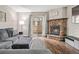 Inviting living room with hardwood floors, a stone fireplace, and a gray, plush sectional sofa at 1060 S Parker Rd # 19, Denver, CO 80231