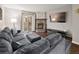 Cozy living room features stone fireplace, exposed brick, and sliding door to backyard at 1060 S Parker Rd # 19, Denver, CO 80231