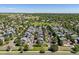Aerial view of the neighborhood with tree-lined streets, manicured lawns, and nearby green spaces at 12427 James Ct, Broomfield, CO 80020