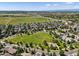 Expansive aerial view showcasing the neighborhood, green spaces, and mountain views at 12427 James Ct, Broomfield, CO 80020