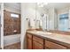 Well-lit bathroom featuring a shower-tub combo with patterned tile and vanity at 12427 James Ct, Broomfield, CO 80020