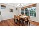 Well-lit dining room with wooden table, six chairs, and a large window at 12427 James Ct, Broomfield, CO 80020