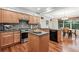 Modern kitchen featuring wooden cabinetry, stainless steel appliances, and granite countertops at 12427 James Ct, Broomfield, CO 80020