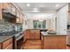 Well-appointed kitchen featuring stone backsplash, modern appliances, and a granite countertop at 12427 James Ct, Broomfield, CO 80020