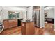 Open concept kitchen and dining space with modern appliances and granite island at 12427 James Ct, Broomfield, CO 80020