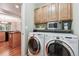 Convenient laundry area equipped with a modern washer and dryer, and cabinetry for storage at 12427 James Ct, Broomfield, CO 80020