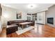 Inviting living room features a fireplace, and a comfortable leather sectional couch at 12427 James Ct, Broomfield, CO 80020