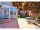 Outdoor patio area featuring stone tile, mature trees, and a dining set at 12427 James Ct, Broomfield, CO 80020