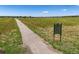 Community walking path with scenic views, signage, and open space for outdoor recreation at 12427 James Ct, Broomfield, CO 80020