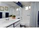 Bathroom with white vanity, blue trim, and a shower-tub combo with a blue and white curtain at 13441 Cherry St, Thornton, CO 80241