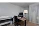 Bedroom with a wooden desk, blue accent wall, neutral carpet, and a bright window at 13441 Cherry St, Thornton, CO 80241