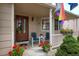 Charming front porch with seating, flower boxes, and a welcoming entrance at 13441 Cherry St, Thornton, CO 80241