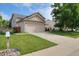View of home with a two car garage and front lawn at 13441 Cherry St, Thornton, CO 80241