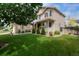 Inviting home exterior with a welcoming porch and lush green lawn at 13441 Cherry St, Thornton, CO 80241