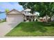 Charming two-story home with a well-manicured lawn and a cozy front porch at 13441 Cherry St, Thornton, CO 80241