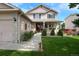 Beautiful two-story home featuring a charming porch, stone accents, and well-kept landscaping at 13441 Cherry St, Thornton, CO 80241