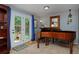 Bright room showcases beautiful piano and outdoor access, creating a harmonious and inviting space at 13441 Cherry St, Thornton, CO 80241