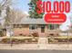 Charming single-story brick home with well-maintained front yard and mature trees on a sunny day at 4121 W 49Th Ave, Denver, CO 80212