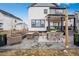 Outdoor patio with comfortable seating, a fire pit, and a dining table, ideal for relaxation and social gatherings at 693 Penn Rd, Elizabeth, CO 80107