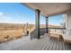 Covered back porch with outdoor seating and views of the plains at 693 Penn Rd, Elizabeth, CO 80107