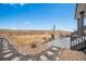 Spacious backyard with a stone patio, dining set, and a fence, perfect for outdoor entertaining and relaxation at 693 Penn Rd, Elizabeth, CO 80107