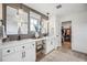 Modern bathroom featuring double sinks, white cabinets, quartz countertops, pendant lights, and walk-in closet at 693 Penn Rd, Elizabeth, CO 80107