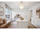 Bright bedroom with large windows, plush seating and chandelier at 693 Penn Rd, Elizabeth, CO 80107