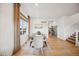 Dining room showcasing hardwood floors, modern decor, and natural light from a large window at 693 Penn Rd, Elizabeth, CO 80107