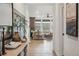 Hallway view leading to bright living room with many windows and hardwood flooring at 693 Penn Rd, Elizabeth, CO 80107