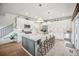 Well-lit kitchen with a large island, stylish pendant lights, and stainless steel appliances at 693 Penn Rd, Elizabeth, CO 80107