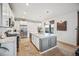 Charming kitchen featuring white cabinets, island, stainless steel appliances, and hardwood floors at 693 Penn Rd, Elizabeth, CO 80107