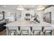 Stunning kitchen island with marble countertop and seating for four provides a gathering spot in the bright kitchen at 693 Penn Rd, Elizabeth, CO 80107