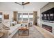 Comfortable living room featuring a fireplace, large windows, and neutral decor at 693 Penn Rd, Elizabeth, CO 80107