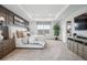 A bright main bedroom featuring a large bed, decorative wall paneling, and an open doorway to the en-suite bath at 693 Penn Rd, Elizabeth, CO 80107