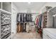 A well-organized walk-in closet with multiple racks and shelves for clothing and shoe storage at 693 Penn Rd, Elizabeth, CO 80107