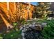 Landscaped backyard with a water feature and wooden fence at 48 Newport St, Denver, CO 80230