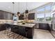 Modern kitchen with an island, stainless steel appliances, and stylish pendant lighting at 48 Newport St, Denver, CO 80230