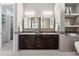 Double vanity bathroom with dark cabinets and granite counters at 48 Newport St, Denver, CO 80230