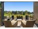 Relaxing patio with seating area, overlooking a grassy common area and community homes at 48 Newport St, Denver, CO 80230