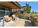 Covered patio with seating area, grill, and views of open space at 48 Newport St, Denver, CO 80230