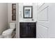 Modern powder room with dark vanity and white toilet at 48 Newport St, Denver, CO 80230