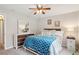 This bedroom features neutral walls, a dresser, and a bed with white linens and throw blanket at 3550 S Harlan St # 335, Denver, CO 80235