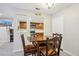 Cozy dining area features a wooden table and chairs, with a view into the adjacent kitchen at 3550 S Harlan St # 335, Denver, CO 80235