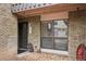 Charming entrance to unit featuring brick facade, decorative window, bear statue and an inviting front door at 3550 S Harlan St # 335, Denver, CO 80235