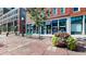 Storefront exterior on a brick building with flower planter and bench at 1510 Wazee St # 3, Denver, CO 80202