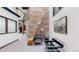 Modern hallway with brick accent wall and seating, with abundant natural light at 1510 Wazee St # 3, Denver, CO 80202