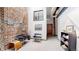 Hallway with exposed brick, stylish seating, and artwork, creating a modern and inviting atmosphere at 1510 Wazee St # 3, Denver, CO 80202